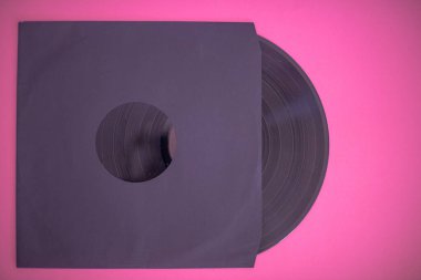 Pembe arka planda izole edilmiş koldaki vinil kaydı