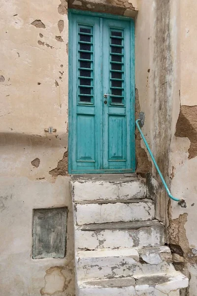 old staircase to painted door