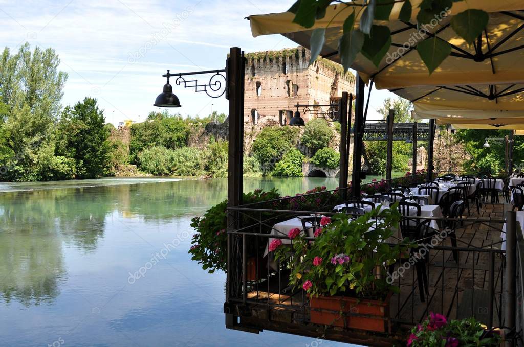 The tower overlooks the terrace of a restaurant overlooking a small lake