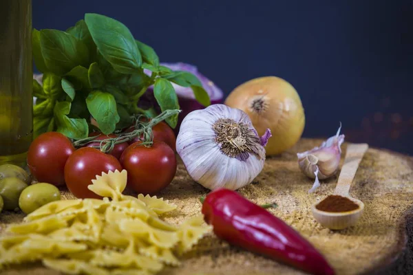 Tomatoes, basil and spices on dark grunge backdrop — Stock Photo, Image