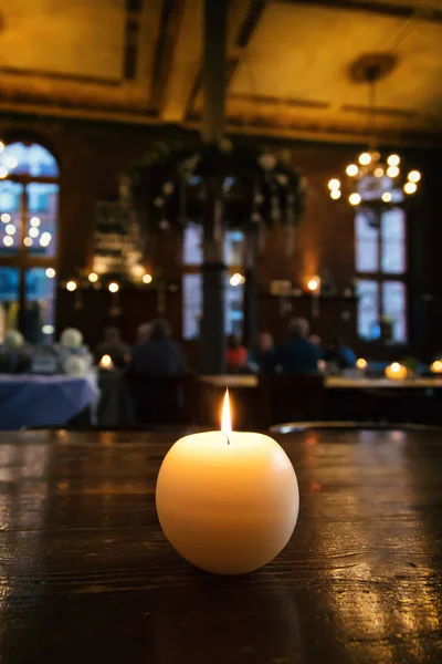 View of a candle on a table of a brewery