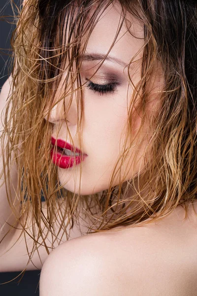 Close up of a young woman in profile, wet hair