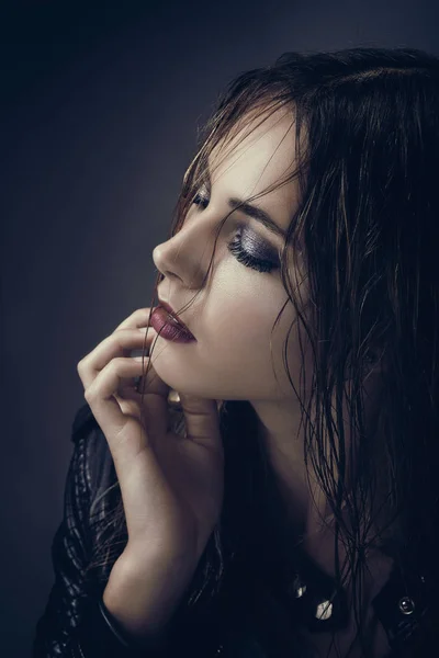 Portrait of a young woman with wet hair, profile, look on the side