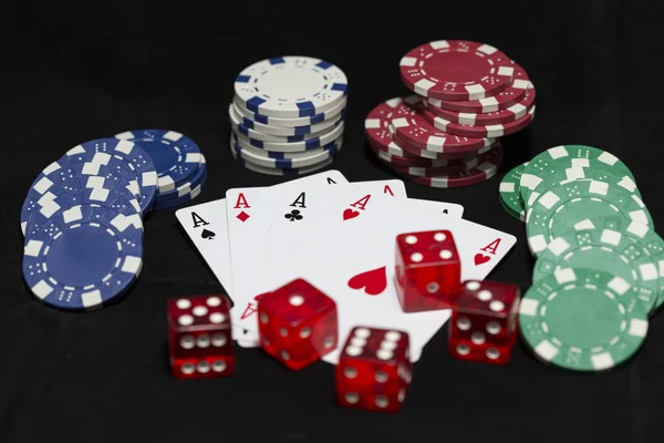 Poker cards and red dice with betting chips.