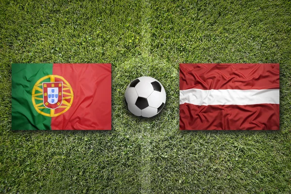 葡萄牙与拉脱维亚旗帜上足球场 — 图库照片