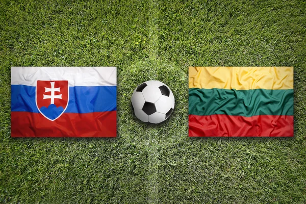 stock image Slovakia vs. Lithuania flags on soccer field