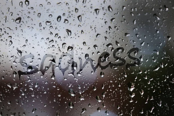 Sadness written on rainy window — Stock Photo, Image