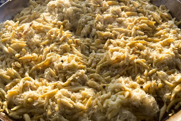 Golden potato dumplings with sauerkraut in a big pan — Stock Photo, Image