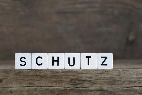 Tyska ordet skydd, skriven i kuber — Stockfoto