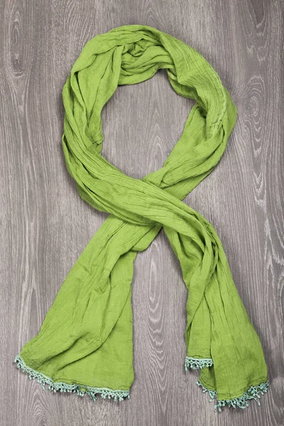 Green scarf on wooden background — Stock Photo, Image