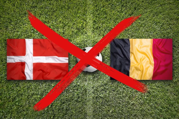 Canceled soccer game, Denmark vs. Belgium flags on green soccer field