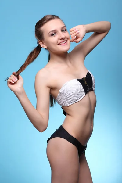 Young beautiful girl in black and white bikini — Stock Photo, Image