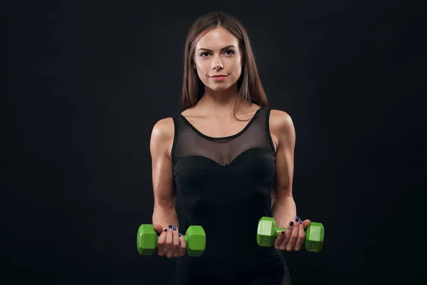 Sporty muscular woman working out with dumbbells — Stock Photo, Image