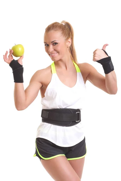 Junge Fitness-Frau glücklich lächelnd mit Apfel in der Hand — Stockfoto