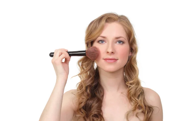 Woman applied blush on her cheeks — Stock Photo, Image