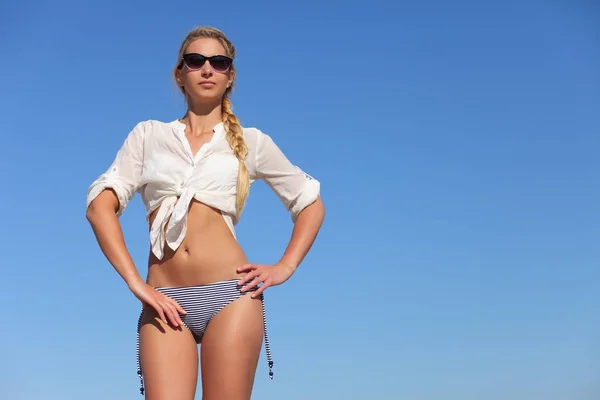 woman in sunshine and bikini on the beach