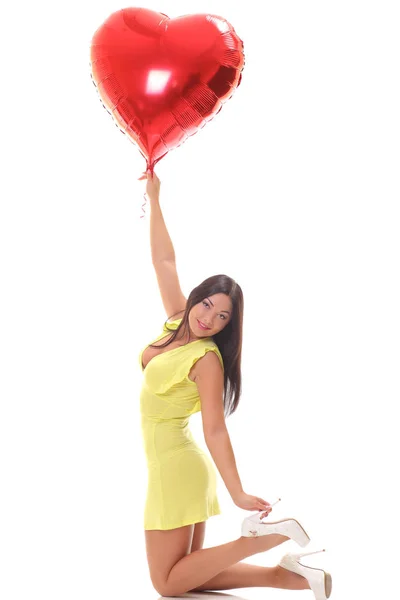 Young woman with heart shape air balloon — Stock Photo, Image
