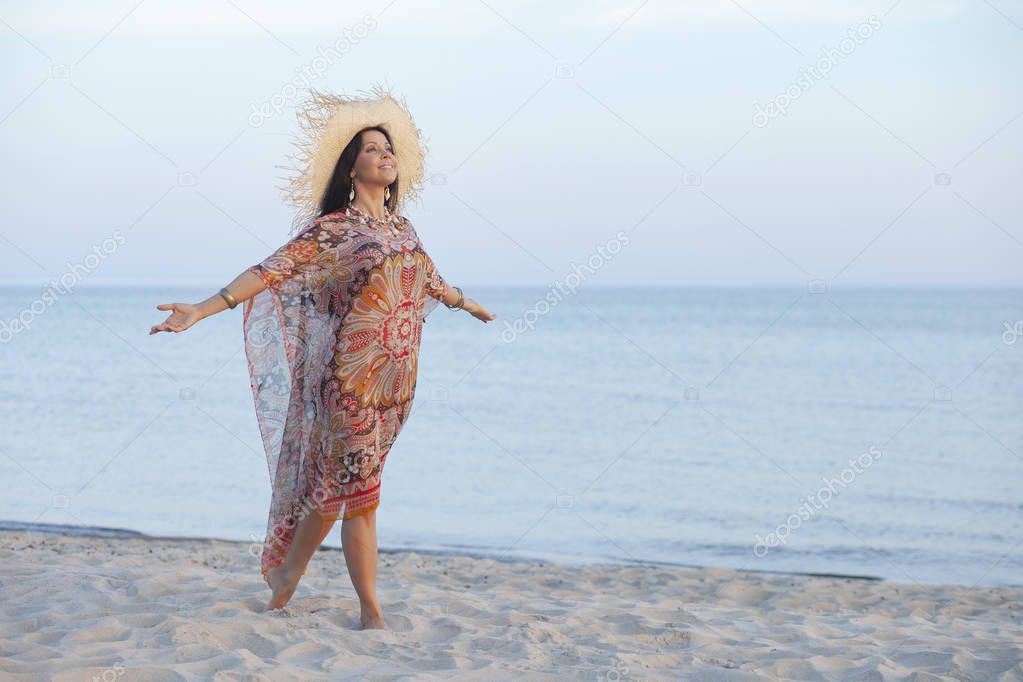 beautiful happy adult woman early morning on the beach