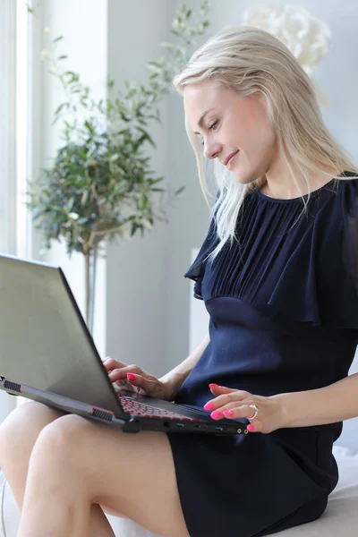 Mujer rubia usando ordenador portátil — Foto de Stock