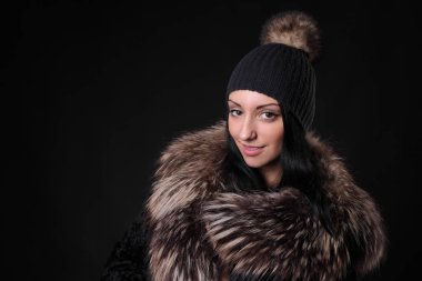 young girl in woolen hat and fur coat