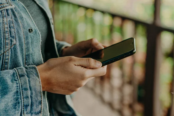 Hands with a black phone. smart phone