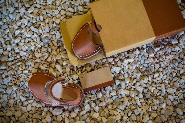 Leather sandals for kids in a box, copy space.