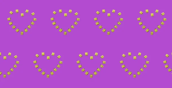 Yellow Connectors XT60 for drone batteries. Outlets laid out in the form of hearts. Credia is repeated many times. Plain pink background image