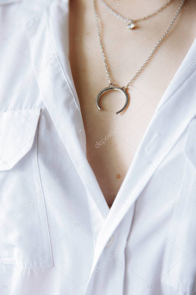Beautiful decoration in the form of a Crescent or horseshoe sees on the chest.