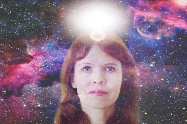 woman with a piercing look in her eyes. above the girl\'s head, white balls are a symbol of openness of mind, clairvoyance. Elements of this image are provided by NASA.