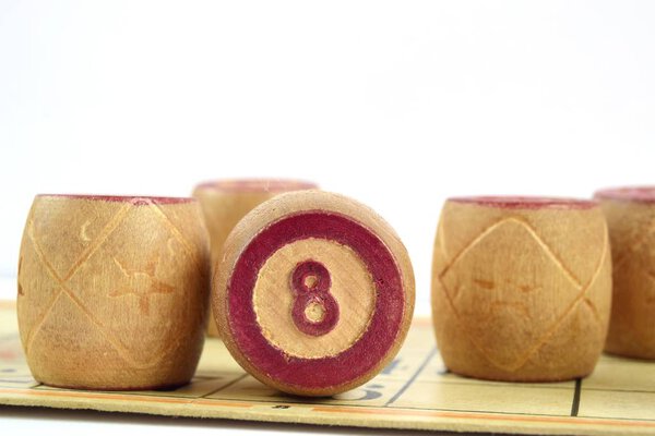 Wooden lotto barrels with number 8. Isolated on a white background. Family bingo game. Conceptual photo.
