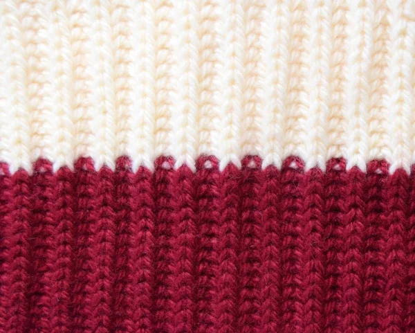 knitted wool background in two colors milk and Burgundy. elastic band binding the texture one in front one wrong