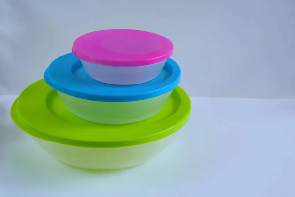 Plastic food containers colored in different sizes.
