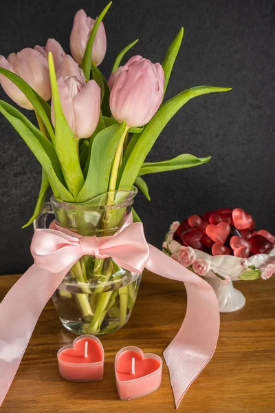 Bouquet of pink tulips with candles and candy — Stock Photo, Image