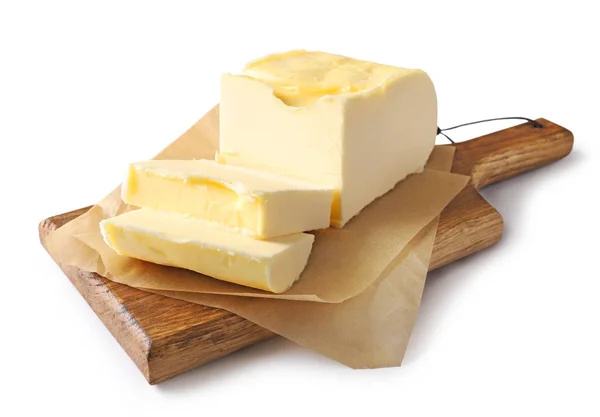 Pedaços de manteiga na tábua de corte de madeira — Fotografia de Stock