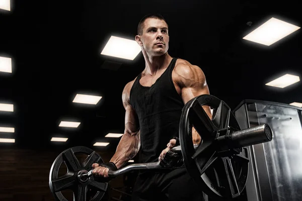 Hombre guapo con grandes músculos, posando en la cámara en el gimnasio —  Fotos de Stock