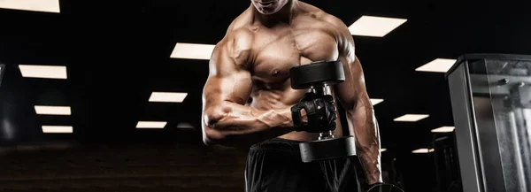 Красивий чоловік з великими м'язами, позує на камеру в спортзалі — стокове фото
