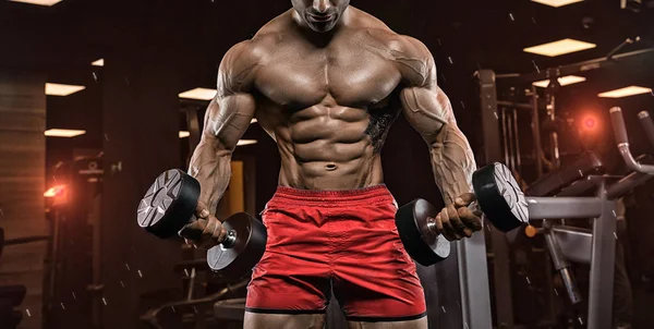 Hombre en el gimnasio. Musculoso culturista chico haciendo ejercicios con barbo —  Fotos de Stock