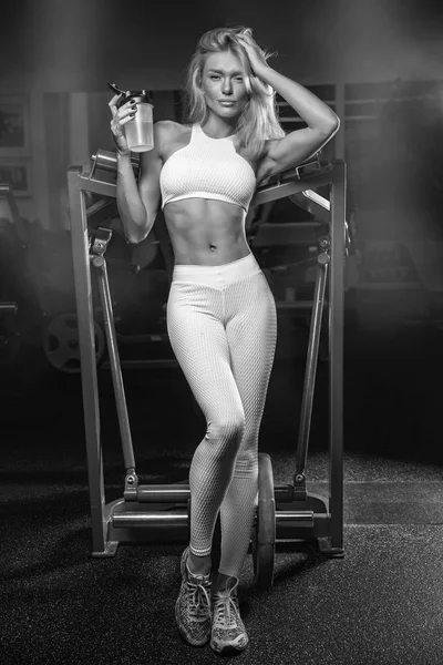 Młoda piękna blondynka na siłownię po sportowych, trzymając shakerze — Zdjęcie stockowe