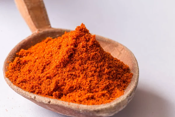 Red pepper powder in wooden spoon — Stock Photo, Image