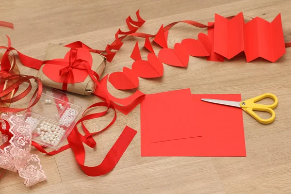 Colorful ribbons, scissors and wrapping paper lie on the table. Gift Wrapping