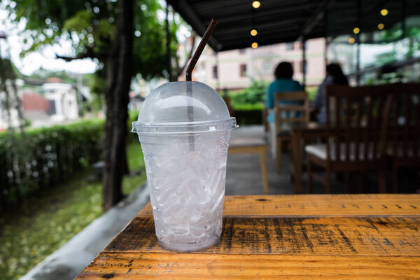 A glass of ice cubes on wooden