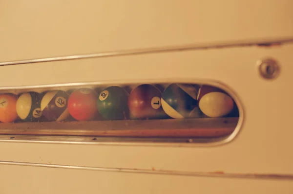 Set of balls for a game of pool billiards on shelves. American p — Stock Photo, Image
