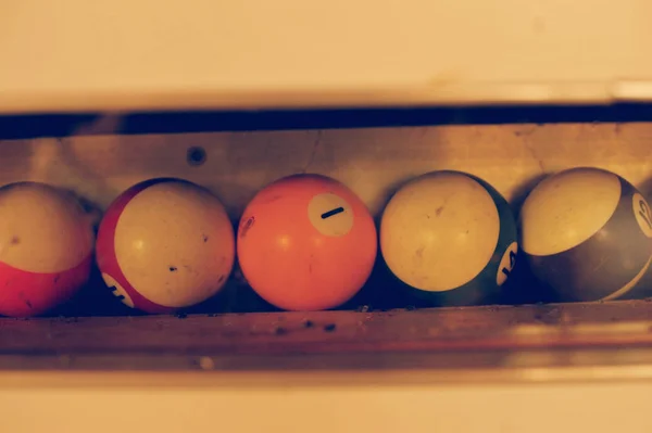 Set of balls for a game of pool billiards on shelves. American p — Stock Photo, Image