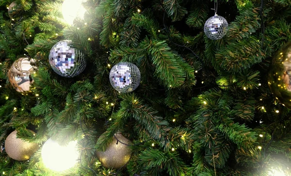 Decorated Christmas tree on blurred, sparkling background — Stock Photo, Image