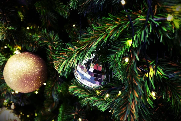 Geschmückter Weihnachtsbaum auf verschwommenem, glitzerndem Hintergrund — Stockfoto