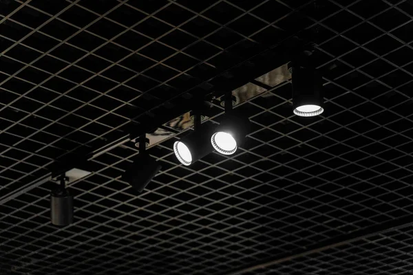Lights system on dark ceiling of the office industrial black building, exhibition hall with led smart light. Ceiling construction