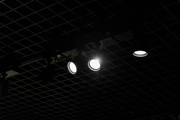 Lights system on dark ceiling of the office industrial black building, exhibition hall with led smart light. Ceiling construction