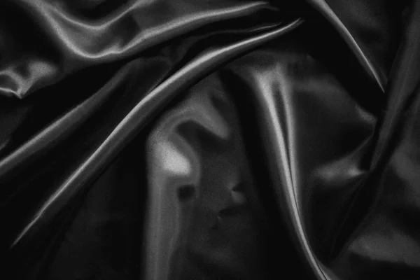 しわ黒サテンの布の質感の背景 — ストック写真