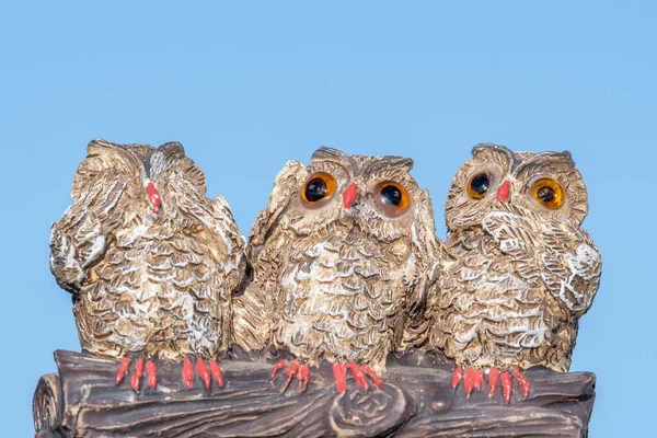 Close up of an ornament of three owls depicting the proverb see no evil hear no evil speak no evil.
