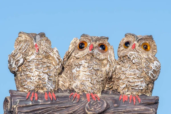 Close up of an ornament of three owls depicting the proverb see no evil hear no evil speak no evil.